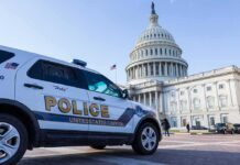 Police vehicle outside United States Capitol building.