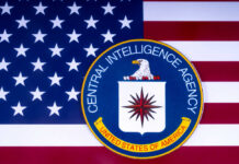 CIA emblem on American flag background.