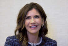 Kristi Noem in black and white checkered jacket.