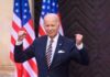 Joe Biden posing with American flags.