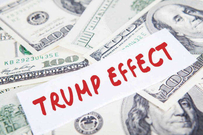 Text Trump Effect over hundred dollar bills