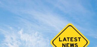 Yellow sign with text Latest News on sky background