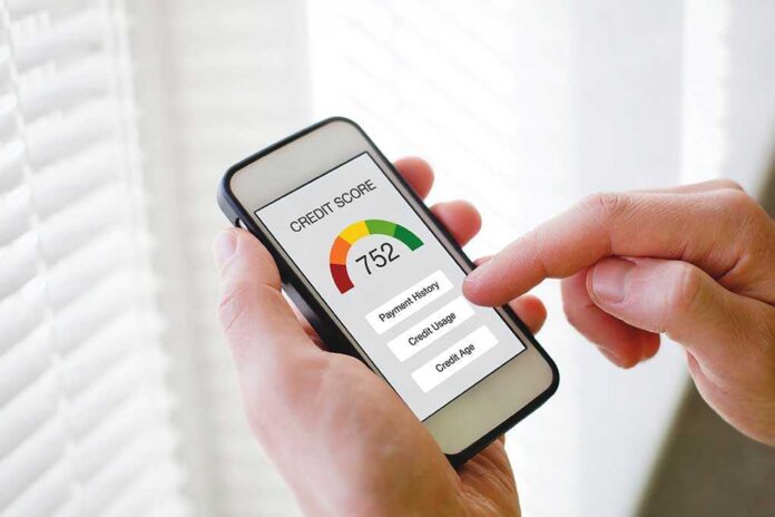 1638738712 featured image Hand holding phone showing credit score app interface