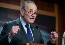 Chuck Schumer in a suit speaking and gesturing emphatically.