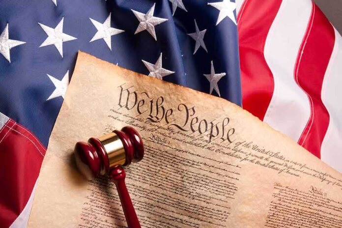 41853862 featured image Gavel on U.S. Constitution with American flag.