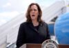 Kamala Harris speaking in front of airplane stairs.
