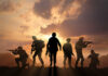Soldiers silhouetted against a sunset, holding weapons.