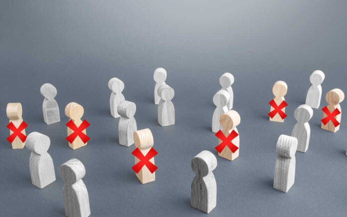 shutterstock_1716859621.jpg featured image Wooden figures with red X marks, signifying eliminated individuals.