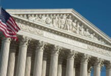 U.S. Supreme Court building with American flag.