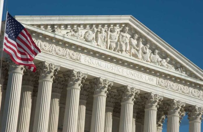 shutterstock_2342942251.jpg featured image U.S. Supreme Court building with American flag.