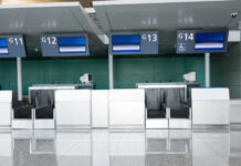 Empty airport check-in counters G11 to G14.