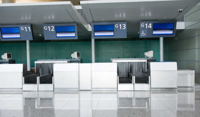 shutterstock_475149466.jpg featured image Empty airport check-in counters G11 to G14.