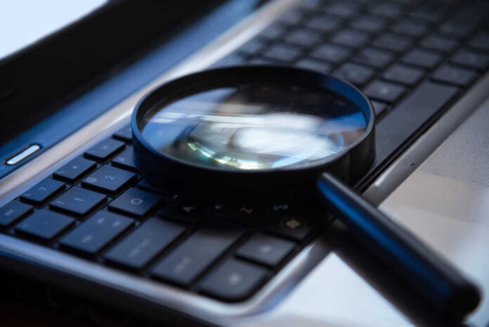 shutterstock_494287042.jpg featured image Magnifying glass on a laptop keyboard.