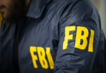 FBI agent in navy blue jacket.