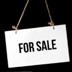 For Sale sign on a rope.