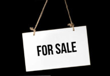 For Sale sign on a rope.