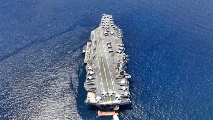 shutterstock_2354939185.jpg featured image Aircraft carrier on open sea with parked planes