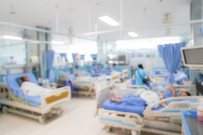 shutterstock_2376696323.jpg featured image Blurred hospital room with multiple patients and nurses