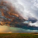 Dramatic storm clouds over a flat landscape.