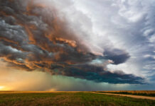 Dramatic storm clouds over a flat landscape.