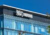 Glass building with Nestle logo and blue sky