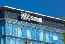 Glass building with Nestle logo and blue sky
