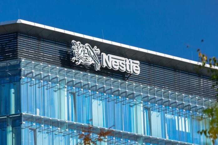 shutterstock_2139818903.jpg featured image Glass building with Nestle logo and blue sky