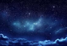 Starry night sky with clouds below