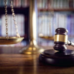 Scales and gavel on a judge's desk.