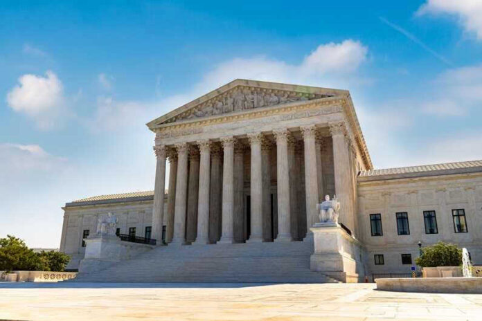 U.S. Supreme Court building exterior under blue sky.