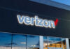 Verizon store exterior with illuminated logo at dusk