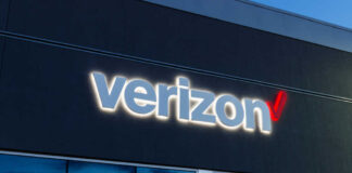 Verizon store exterior with illuminated logo at dusk