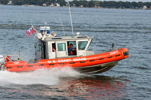 U.S. Coast Guard boat speeding through water