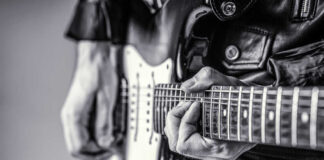 Close-up of a musician's hands playing an electric guitar