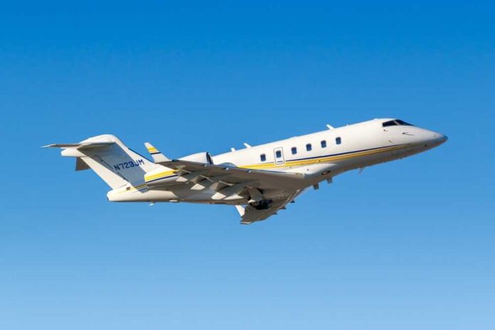 A private jet taking off against a clear blue sky