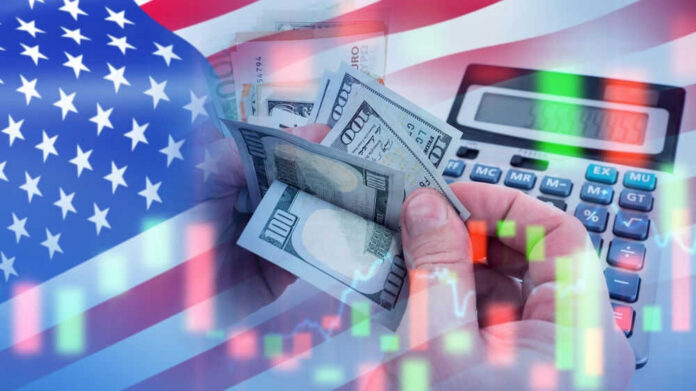 shutterstock_2482828605.jpg USA flag calculator and hands holding dollars overlapping