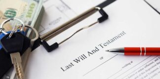 A last will and testament document with a pen, keys, and cash