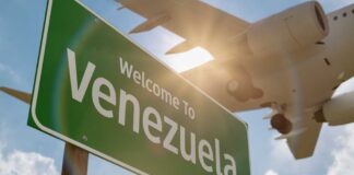 Welcome sign to Venezuela with an airplane flying overhead