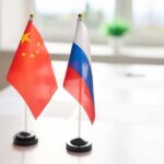 Chinese and Russian flags displayed on a table