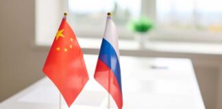 Chinese and Russian flags displayed on a table