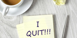 Note with I QUIT near coffee, pen, paper ball.