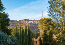 Hollywood sign on hills, surrounded by trees.