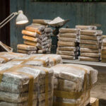 Stacks of wrapped packages in a dimly lit warehouse