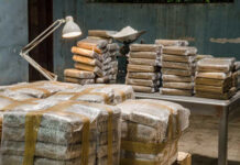 Stacks of wrapped packages in a dimly lit warehouse