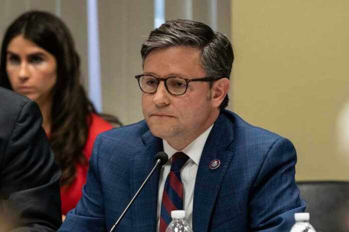 shutterstock_2290525915.jpg Mike Johnson in suit speaking.