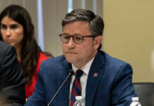 Mike Johnson in suit speaking.