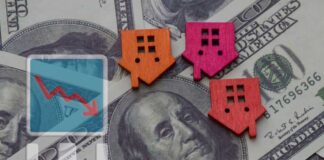 Colorful house icons on a background of hundred dollar bills with a downward trend graph