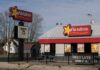 Exterior view of a Hardee's fast food restaurant with a sign and menu