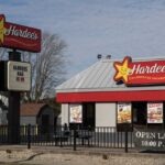 Exterior view of a Hardee's fast food restaurant with a sign and menu