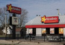 Exterior view of a Hardee's fast food restaurant with a sign and menu